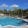 a pool with a deck and trees in the background