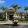 a building with palm trees and a golf cart in front of it